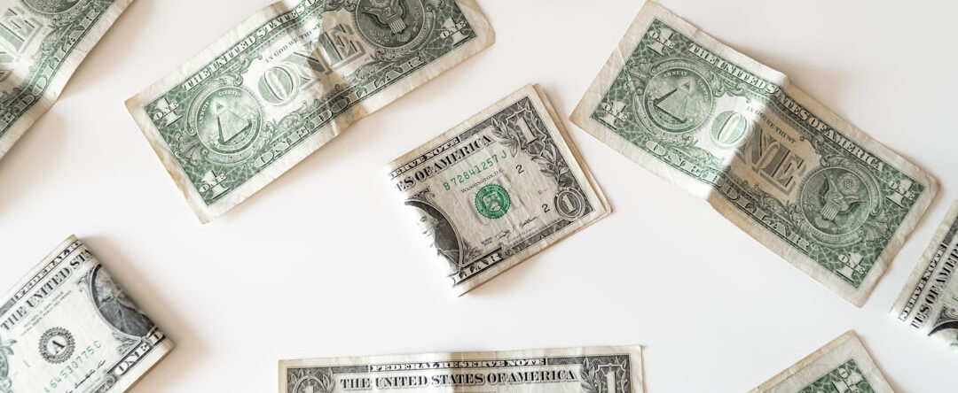 several used dollar bills laid out on a table